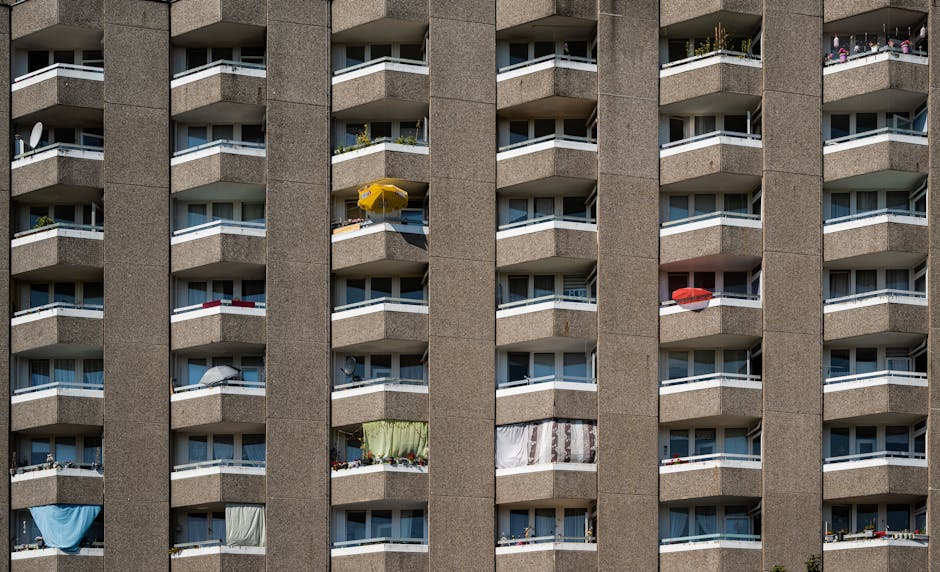 A detailed view of an urban high-rise apartment building facade with modern balconies in Berlin.
